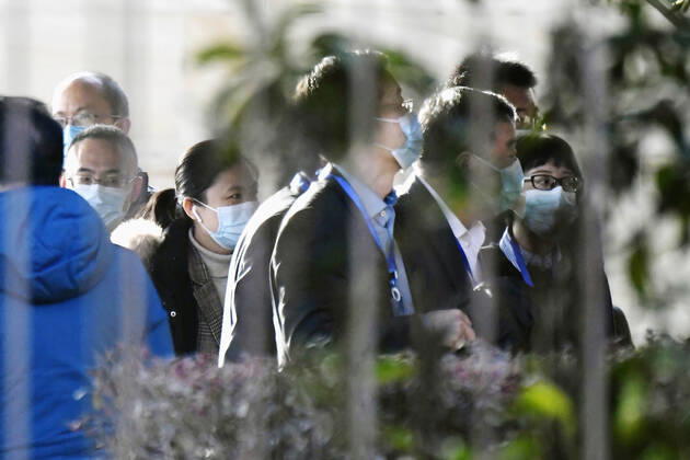 WHO probe into coronavirus origins in Wuhan Chinese officials arrive at a hotel in Wuhan, where an international team of experts from the World Health Organization has stayed for a probe into coronavirus origins, on Jan. 29, 2021. 