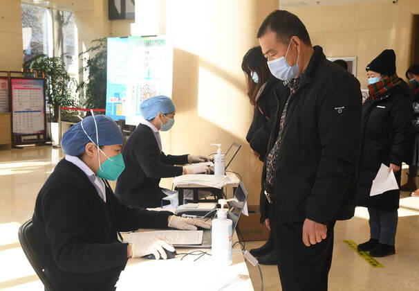 (210129) -- BEIJING, Jan. 29, 2021 -- Medical workers register recipient information before the COVID-19 vaccination at a temporary vaccination site in Haidian District of Beijing, capital of China, Jan. 29, 2021. The administration of the second dose of COVID-19 vaccines for key groups of residents throughout Beijing started on Jan. 22, and is expected to conclude before Feb. 8. ) CHINA-BEIJING-COVID-19-VACCINATION-2ND-DOSE (CN) RenxChao 