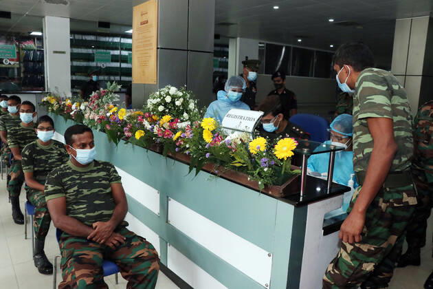 (210129) -- COLOMBO, Jan. 29, 2021 -- Army men wait to get the COVID-19 vaccination at the Army Hospital in Colombo, Sri Lanka, Jan. 29, 2021. Sri Lanka s health officials on Friday kicked off the country s first COVID-19 vaccination program by inoculating a senior consultant physician at the National Infectious Disease Hospital (IDH) who has been in the front lines of the pandemic, local media reported. Dr. Ananda Wijewickrama was the first medical officer to receive the jab on Friday morning, which was monitored by hospital staff and government officials. A senior nurse at the IDH was the second to receive the jab while three military officers also received the jab at the Army Hospital in Colombo. The vaccination program is u 
