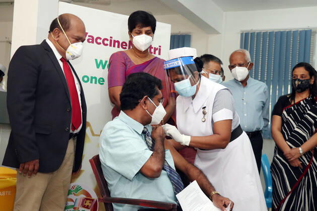 (210129) -- COLOMBO, Jan. 29, 2021 -- Dr. Ananda Wijewickrama receives a dose of COVID-19 vaccine at the National Infectious Disease Hospital (IDH) in Colombo, Sri Lanka, Jan. 29, 2021. Sri Lanka s health officials on Friday kicked off the country s first COVID-19 vaccination program by inoculating a senior consultant physician at the National Infectious Disease Hospital (IDH) who has been in the front lines of the pandemic, local media reported. Dr. Ananda Wijewickrama was the first medical officer to receive the jab on Friday morning, which was monitored by hospital staff and government officials. A senior nurse at the IDH was the second to receive the jab while three military officers also received the jab at the Army Hospital i 