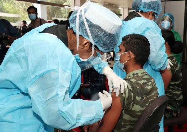 (210129) -- COLOMBO, Jan. 29, 2021 -- An army man gets the COVID-19 vaccination at the Army Hospital in Colombo, Sri Lanka, Jan. 29, 2021. Sri Lanka s health officials on Friday kicked off the country s first COVID-19 vaccination program by inoculating a senior consultant physician at the National Infectious Disease Hospital (IDH) who has been in the front lines of the pandemic, local media reported. Dr. Ananda Wijewickrama was the first medical officer to receive the jab on Friday morning, which was monitored by hospital staff and government officials. A senior nurse at the IDH was the second to receive the jab while three military officers also received the jab at the Army Hospital in Colombo. The vaccination program is under 