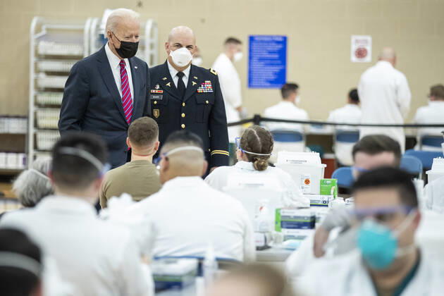 US President Joe Biden is is escorted by the Director of Walter Reed National Military Medical Center Colonel Andrew Barr (R) on a tour of a COVID-19 vaccination center at Walter Reed National Military Medical Center in Bethesda, Maryland on Friday, January 29, 2021. President Biden is to visit with wounded service members.  WAX20210129288 SHAWNxTHEW
