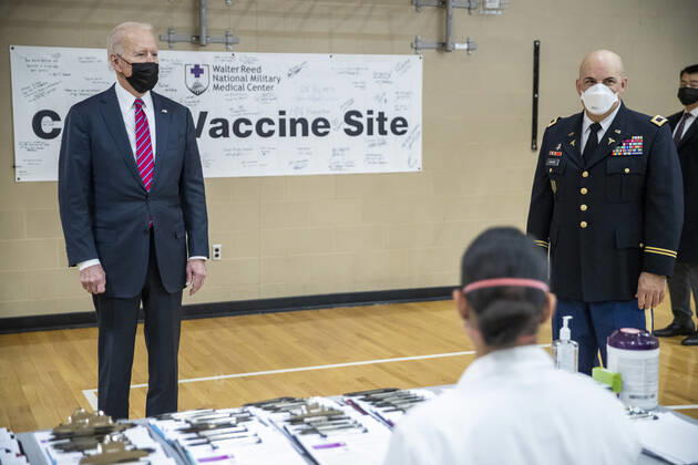 US President Joe Biden is is escorted by the Director of Walter Reed National Military Medical Center Colonel Andrew Barr (R) on a tour of a COVID-19 vaccination center at Walter Reed National Military Medical Center in Bethesda, Maryland on Friday, January 29, 2021. President Biden is to visit with wounded service members.  WAX20210129291 SHAWNxTHEW