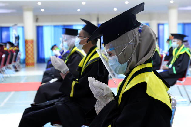 Indonesia: Student Graduation during the Covid-19 pandemic Students pray at the end of the Graduation Ceremony during the pandemic at the State Islamic University of Palembang, South Sumatra, Saturday, January 30, 2021 Palembang South Sumatra Indonesia Copyright: AdamxRachman