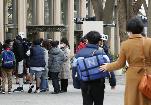 Japan s private junior high school entrance exams Students wait to have their temperature taken before entering the venue of their entrance exam at a private junior high school in Tokyo on Feb. 1, 2021, amid the novel coronavirus pandemic. Entrance exams to private junior high school began the same day in Tokyo for enrollment in the coming spring. 