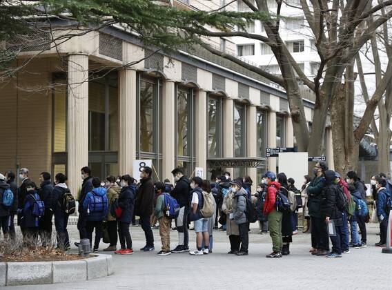 Japan s private junior high school entrance exams Students wait to have their temperature taken before entering the venue of their entrance exam at a private junior high school in Tokyo on Feb. 1, 2021, amid the novel coronavirus pandemic. Entrance exams to private junior high school began the same day in Tokyo for enrollment in the coming spring. 