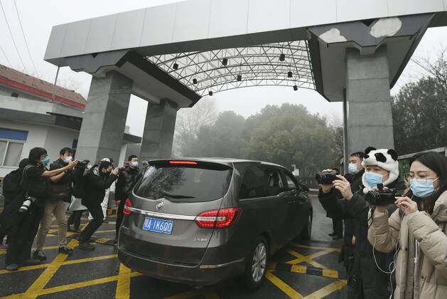 WHO probe into coronavirus origins in Wuhan A vehicle carrying members of the World Health Organization s team investigating the origins of the coronavirus pandemic enters an infectious disease prevention center in Wuhan, China, on Feb. 1, 2021. 