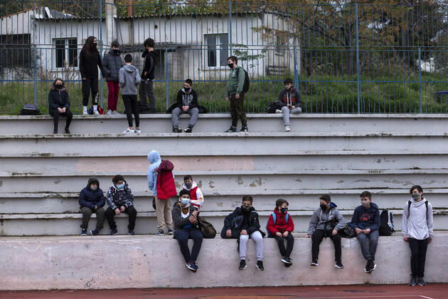 (210201) -- ATHENS, Feb. 1, 2021 -- Students wearing face masks are seen in the schoolyard at a middle school in Glyfada, a southern suburb of Athens, Greece, Feb. 1, 2021. Middle schools in Greece reopened on Feb. 1 after more than two months of online learning, but high schools in red zones with heavier epidemiological load remain closed, while high schools in low-risk zones reopened on Monday. ) GREECE-ATHENS-MIDDLE SCHOOL-REOPENED MariosxLolos 
