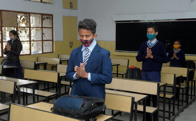 CHANDIGARH, INDIA - FEBRUARY 1: Students attend morning prayers in their classroom after classes resumed for grades 6 to 8 for the first time since the lockdown, at a government school in Sector 50, on February 1, 2021 in Chandigarh, India. (Photo by Ravi Kumar Hindustan Times) Daily Life Amid Covid-19 Pandemic In India