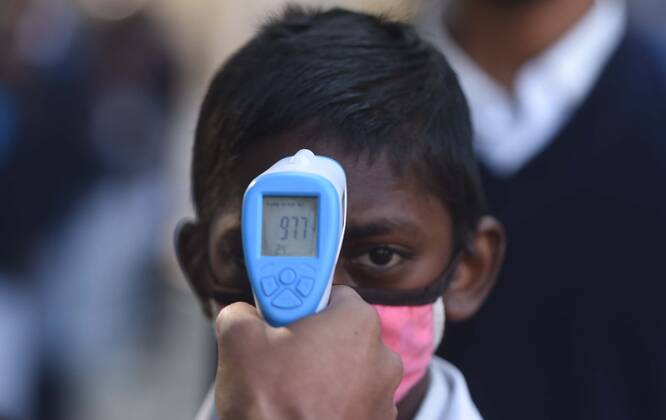 GURUGRAM, INDIA - FEBRUARY 1: A student undergoes thermal screening before entering Model Senior Secondary School Urban Estate at Sector 4, on February 1, 2021 in Gurugram, India. Schools in Gurugram reopened for 6th to 8th standard today. (Photo by Vipin Kumar Hindustan Times) Daily Life Amid Covid-19 Pandemic In India