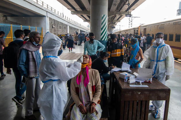 MUMBAI, INDIA - FEBRUARY 1: A healthcare worker conducts swab tests of travellers for coronavirus infection, at Dadar station, on February 1, 2021 in Mumbai, India. (Photo by Pratik Chorge Hindustan Times) Daily Life Amid Covid-19 Pandemic In India