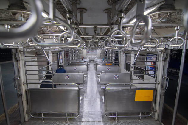 MUMBAI, INDIA - FEBRUARY 1: Few travellers in a suburban local train on the first day when local train services starts for general public, at Kalyan, on February 1, 2021 in Mumbai, India. Travel by local trains, lifeline for millions of people living in Mumbai and surrounding satellite towns, was severely restricted after the coronavirus outbreak in March 2020. (Photo by Pratik Chorge Hindustan Times) Mumbai Local Trains Resume Services For General Public