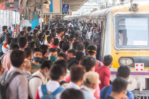 MUMBAI, INDIA - FEBRUARY 1: A rush of travellers waiting to board a suburban local train Dadar station on the first day when local train services starts for general public, on February 1, 2021 in Mumbai, India. Travel by local trains, lifeline for millions of people living in Mumbai and surrounding satellite towns, was severely restricted after the coronavirus outbreak in March 2020. (Photo by Pratik Chorge Hindustan Times) Mumbai Local Trains Resume Services For General Public