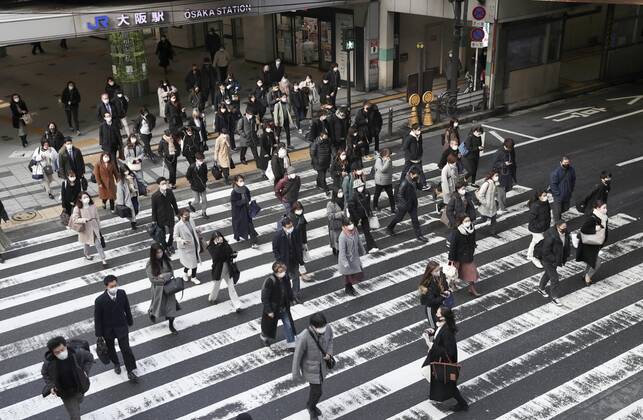 Japan to extend virus emergency to March 7 as hospitals strained People wearing face masks walk in front of JR Osaka Station on Feb. 2, 2021. The Japanese government is set to extend a coronavirus state of emergency for Tokyo, Osaka and other regions by one month to March 7 in view of manpower-strapped hospitals amid a surge in serious patients. 