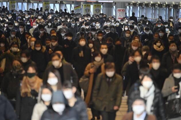 Tokyo scene amid coronavirus pandemic People wearing masks pass through JR Shinagawa Station in Tokyo on their way to work on Jan. 7, 2021, amid the novel coronavirus pandemic. 
