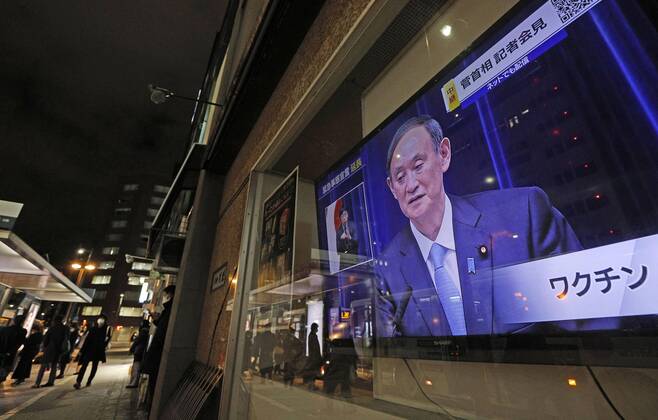Japan extends virus emergency for Tokyo and other regions A roadside television in Fukuoka shows Japanese Prime Minister Yoshihide Suga holding a press conference on Feb. 2, 2021, to announce an extension of the coronavirus state of emergency for Tokyo, Fukuoka and other regions by one month to March 7 in view of manpower-strapped hospitals. 