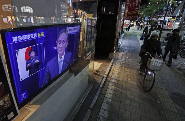 Japan extends virus emergency for Tokyo and other regions A roadside television in Fukuoka shows Japanese Prime Minister Yoshihide Suga holding a press conference on Feb. 2, 2021, to announce an extension of the coronavirus state of emergency for Tokyo, Fukuoka and other regions by one month to March 7 in view of manpower-strapped hospitals. 