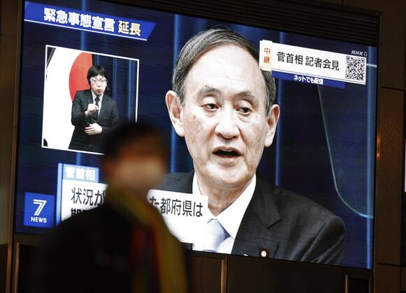 Japan extends virus emergency for Tokyo and other regions A roadside screen in Osaka shows Japanese Prime Minister Yoshihide Suga holding a press conference on Feb. 2, 2021, to announce an extension of the coronavirus state of emergency for Tokyo, Osaka and other regions by one month to March 7 in view of manpower-strapped hospitals. 
