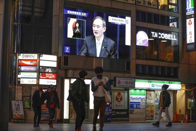 Japan extends virus emergency for Tokyo and other regions A roadside screen in Osaka shows Japanese Prime Minister Yoshihide Suga holding a press conference on Feb. 2, 2021, to announce an extension of the coronavirus state of emergency for Tokyo, Osaka and other regions by one month to March 7 in view of manpower-strapped hospitals. 