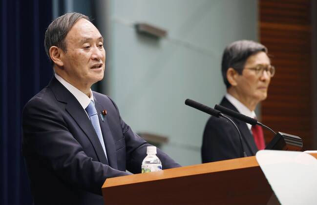 Japan extends virus emergency for Tokyo and other regions Japanese Prime Minister Yoshihide Suga (L) attends a press conference in Tokyo on Feb. 2, 2021, after he declared an extension of the coronavirus state of emergency for Tokyo, Osaka and other regions by one month to March 7 in view of manpower-strapped hospitals. Seen on the right is Shigeru Omi, the doctor chairing the government s coronavirus subcommittee. 