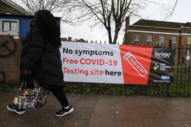 February 2, 2021, London, England, United Kingdom: A woman walks past a covid test site In Tottenham. The north London neighbourhood is among the seven areas in the country the UK government started Ã¢â‚¬oesurge testingÃ¢â‚¬Â to find and isolate covid-19 cases caused by South African variant of the coronavirus. London United Kingdom - ZUMAs262 20210202_zip_s262_005 Copyright: xTayfunxSalcix