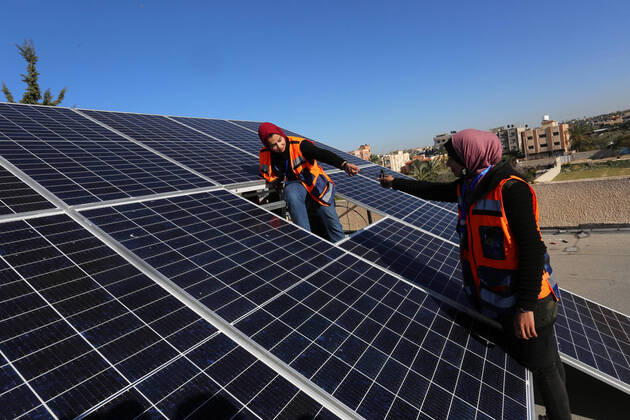 February 1, 2021, Khan Yunis, Gaza Strip, Palestinian Territory: Palestinian graduate girls install solar energy panels on the roof of a school, in Khan Yunis in the southern Gaza Strip on January 2, 2021. The first girls team in the Gaza Strip to work on installing solar panels in light of the deteriorating economic conditions in the Gaza Strip. According to figures by the Palestinian Central Bureau of Statistics, the unemployment rate in Gaza increased by 3.6% in the second quarter of 2020 compared to the previous quarter, and by 2.4% compared to the second quarter of 2019, now standing at 49.1 Khan Yunis Palestinian Territory - ZUMAap3_ 20210201_zaf_ap3_128 Copyright: xAshrafxAmrax