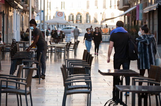 February 2, 2021, Malaga, Spain: A worker stacking up chairs outside the empty La plaza Malaga restaurant terrace during the closure of the hospitality sector and non-essential activities as part of a partial lockdown..For two weeks, besides the limit on mobility between cities, many municipalities and Costa del Sol districts (including the Malaga capital) will have to close bars, restaurants and stores as measures to curb the spread of the coronavirus pandemic. In the lead of Andalusia, Malaga is the city with more daily coronavirus infections and a high rate of hospitalizations. Malaga Spain - ZUMAs197 20210202_zab_s197_015 Copyright: xJesusxMeridax