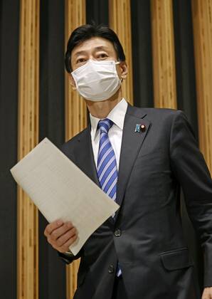 Virus-related laws revised Japanese economic revitalization minister Yasutoshi Nishimura meets the press in Tokyo on Feb. 3, 2021, after parliament enacted revisions to the coronavirus special measures law and the infectious disease law. 