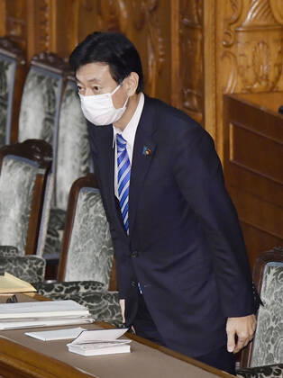 Virus-related laws revised Japanese economic revitalization minister Yasutoshi Nishimura bows during a House of Councillors plenary session in Tokyo on Feb. 3, 2021, after the upper chamber passed and enacted revisions to the coronavirus special measures law and the infectious disease law. 