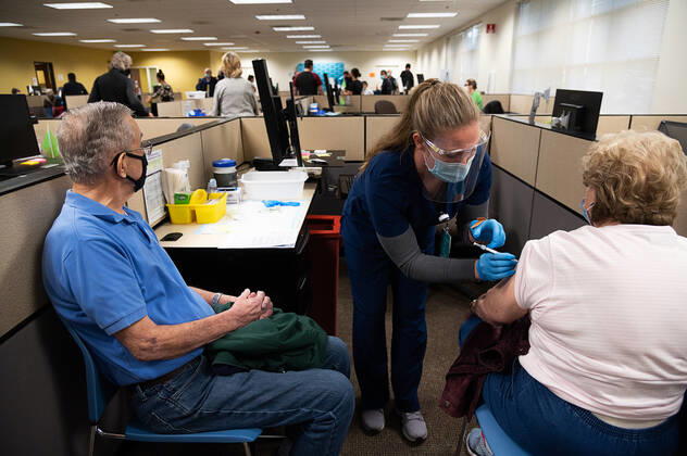 February 4, 2021, Sacramento, CA, USA: Medical assistant Lindsey Laubsch administers the Pfizer COVID-19 vaccine to Joan Vykukal, 88, of Gold River as her husband during a large -scale COVID-19 vaccine clinic by Sutter Health at on Thursday, Feb. 4, 2021 in Sacramento. Sutter Health are vaccinating 800 seniors and healthcare workers with their first doses of the Pfizer COVID-19 vaccine. Sacramento USA - ZUMAj89_ 1000627566st Copyright: xPaulxKitagakixJr.x