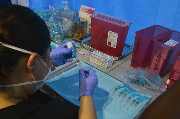 Medical staff prepare syringes with Moderna COVID-19 vaccine doses at the Kedren Community Health Center in Los Angeles on Thursday, February 4, 2021. Seniors 65 and older can now move to the head of the line to receive their vaccinations without an appointment. Director Jerry Abraham and his team at Kedren have pioneered workarounds to ensure that the people in South L.A. who need the vaccine the most , healthcare workers and those over 65 can get it.  LAP2021020424 JIMxRUYMEN