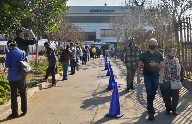 Residents wait in line to receive COVID-19 leftover doses of the Moderna vaccine at the Kedren Community Health Center in Los Angeles on Thursday, February 4, 2021. Seniors 65 and older can now move to the head of the line to receive their vaccinations without an appointment. Director Jerry Abraham and his team at Kedren have pioneered workarounds to ensure that the people in South L.A. who need the vaccine the most , healthcare workers and those over 65 can get it.  LAP2021020409 JIMxRUYMEN