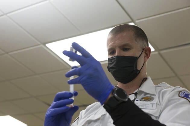 February 5, 2021, Seattle, Washington, USA: JON LEFFINGWELL, a paramedic with the Seattle Fire Department, prepares a dose of the Moderna COVID-19 vaccine at the Ethiopian Community of Seattle in the Rainier Valley on Friday, February 5, 2021. To date, the Seattle Fire Department Mobile Vaccination Teams have vaccinated 2,436 vulnerable Seattle residents and workers since launching its vaccination effort on January 14, 2021. Seattle USA - ZUMAg235 20210205_zap_g235_001 Copyright: xPaulxChristianxGordonx