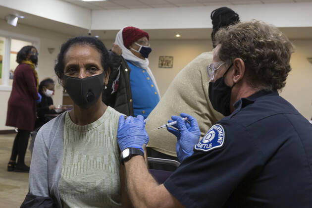 February 5, 2021, Seattle, Washington, USA: DANIEL CLARK, a member of the Seattle Fire Department, administers a dose of the Moderna COVID-19 vaccine to a patient at the Ethiopian Community of Seattle in the Rainier Valley on Friday, February 5, 2021. To date, the Seattle Fire Department Mobile Vaccination Teams have vaccinated 2,436 vulnerable Seattle residents and workers since launching its vaccination effort on January 14, 2021. Seattle USA - ZUMAg235 20210205_zap_g235_005 Copyright: xPaulxChristianxGordonx