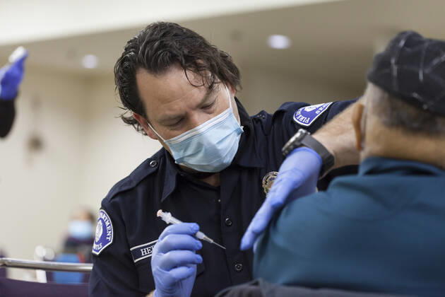 February 5, 2021, Seattle, Washington, USA: ALAN HEDDINGS, a member of the Seattle Fire Department, administers a dose of the Moderna COVID-19 vaccine to a patient at the Ethiopian Community of Seattle in the Rainier Valley on Friday, February 5, 2021. To date, the Seattle Fire Department Mobile Vaccination Teams have vaccinated 2,436 vulnerable Seattle residents and workers since launching its vaccination effort on January 14, 2021. Seattle USA - ZUMAg235 20210205_zap_g235_006 Copyright: xPaulxChristianxGordonx