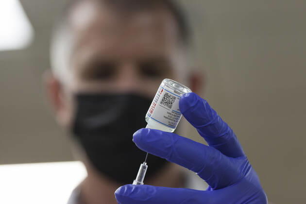 February 5, 2021, Seattle, Washington, USA: JON LEFFINGWELL, a paramedic with the Seattle Fire Department, prepares a dose of the Moderna COVID-19 vaccine at the Ethiopian Community of Seattle in the Rainier Valley on Friday, February 5, 2021. To date, the Seattle Fire Department Mobile Vaccination Teams have vaccinated 2,436 vulnerable Seattle residents and workers since launching its vaccination effort on January 14, 2021. Seattle USA - ZUMAg235 20210205_zap_g235_019 Copyright: xPaulxChristianxGordonx