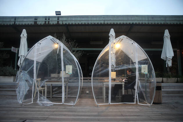 (210205) -- JERUSALEM, Feb. 5, 2021 -- A man sits in an outdoor dining bubble amid the COVID-19 pandemic in Jerusalem, on Feb. 5, 2021. (Photo by Xinhua) MIDEAST-JERUSALEM-COVID-19-DINING BUBBLE MuammarxAwad 