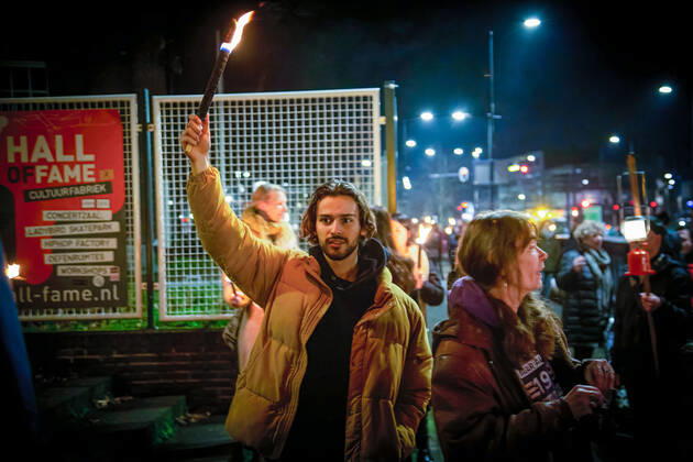 February 5, 2021, Tilburg, North Brabant, Netherlands: A protester holding high a torch during the demonstration..A torch-lit protest was held against the new measures that the government imposed in January to fight the spread of the Coronavirus Covid-19 pandemic. The Anti-Curfew and Anti-lockdown demonstration were peaceful. A strict curfew is applied in the Netherlands between 21:00-04:30. Violent protests against the Covid 19 measures took place in January. Tilburg Netherlands - ZUMAs197 20210205_zaa_s197_258 Copyright: xNikxOikox