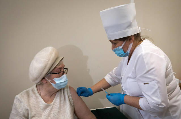 SEVASTOPOL, RUSSIA - FEBRUARY 8, 2021: A patient and a medical worker during vaccination with the Gam-COVID-Vak (Sputnik V) vaccine against COVID-19 at Dasha Sevastopolskaya Hospital No 5. Sergei Malgavko TASS  TS0F642B