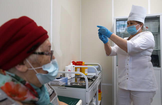 SEVASTOPOL, RUSSIA - FEBRUARY 8, 2021: A patient and a medical worker during vaccination with the Gam-COVID-Vak (Sputnik V) vaccine against COVID-19 at Dasha Sevastopolskaya Hospital No 5. Sergei Malgavko TASS  TS0F642C
