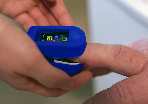 SEVASTOPOL, RUSSIA - FEBRUARY 8, 2021: A medical worker puts on a fingertip pulse oximeter on a patient before vaccination with the Gam-COVID-Vak (Sputnik V) vaccine against COVID-19 at Dasha Sevastopolskaya Hospital No 5. Starting February 8, Sevastopol starts a mass COVID-19 vaccination campaign; earlier, the vaccine was available to medical workers and teachers only. Sergei Malgavko TASS  TS0F6437