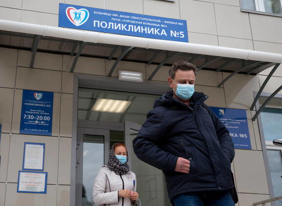 SEVASTOPOL, RUSSIA - FEBRUARY 8, 2021: People walk out of Dasha Sevastopolskaya Hospital No 5. Starting February 8, Sevastopol starts a mass COVID-19 vaccination campaign; earlier, the vaccine was available to medical workers and teachers only. Sergei Malgavko TASS  TS0F643A