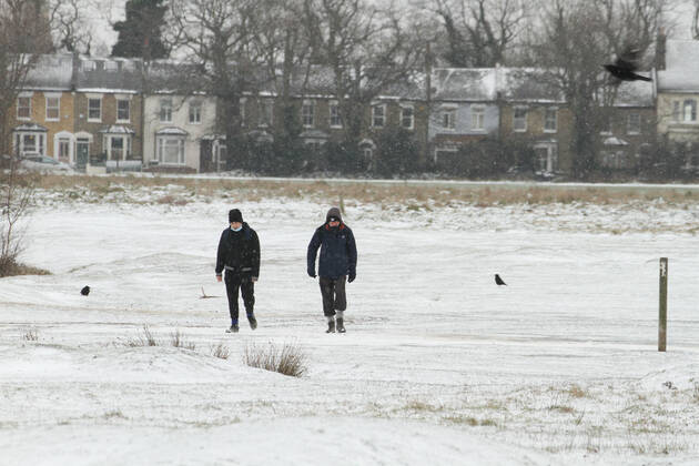 February 8, 2021, London, United Kingdom: People walk through a snow covered Wanstead Park in Redbridge..Heavy snow and ice has brought disruption to parts of the UK, with London receiving around 5cm of snow. Storm Darcy s strong easterly winds have plummeted temperatures in parts of the UK to below minus one. London United Kingdom - ZUMAs197 20210208_zaa_s197_080 Copyright: xDavidxMbiyux