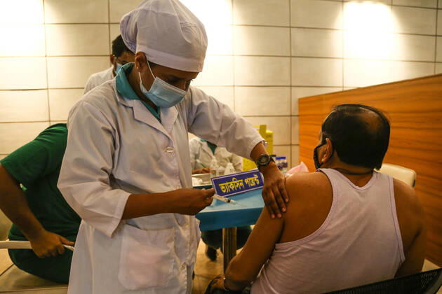 Bangladesh: Covid-19 vaccination drive begins in Dhaka A man getting a shot with the dose of Covishield covid-19 vaccine during the vaccination drive. Dhaka Dhaka Division Bangladesh Copyright: NahidxHasan
