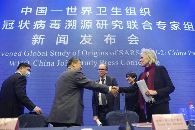 WHO investigation into coronavirus origins in Wuhan World Health Organization (R) and Chinese experts shake hands after a press conference in Wuhan, China, on Feb. 9, 2021. 