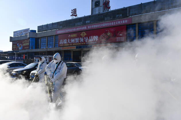 (210209) -- TONGHUA, Feb. 9, 2021 -- Staff members disinfect the square in front of the railway station of Tonghua City, northeast China s Jilin Province, Feb. 9, 2021. ) CHINA-JILIN-TONGHUA-COVID-19-DISINFECTION (CN) XuxChang 