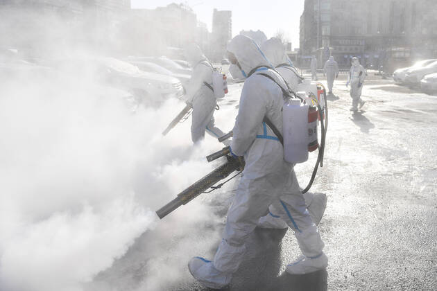 (210209) -- TONGHUA, Feb. 9, 2021 -- Staff members disinfect the square in front of the railway station of Tonghua City, northeast China s Jilin Province, Feb. 9, 2021. ) CHINA-JILIN-TONGHUA-COVID-19-DISINFECTION (CN) XuxChang 