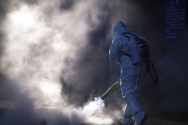 (210209) -- TONGHUA, Feb. 9, 2021 -- A staff member disinfects the square in front of the railway station of Tonghua City, northeast China s Jilin Province, Feb. 9, 2021. ) CHINA-JILIN-TONGHUA-COVID-19-DISINFECTION (CN) XuxChang 