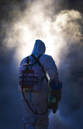 (210209) -- TONGHUA, Feb. 9, 2021 -- A staff member disinfects the square in front of the railway station of Tonghua City, northeast China s Jilin Province, Feb. 9, 2021. ) CHINA-JILIN-TONGHUA-COVID-19-DISINFECTION (CN) XuxChang 