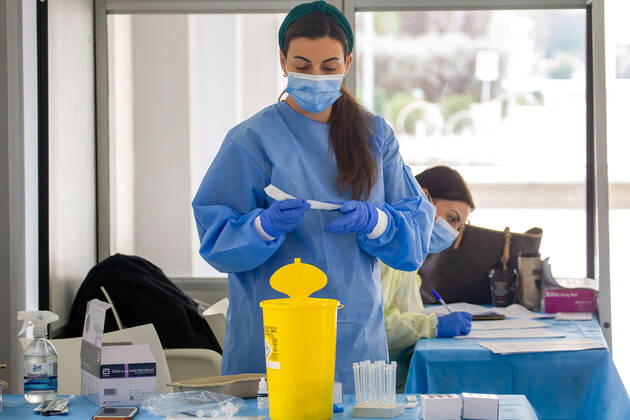 February 9, 2021, Nicosia, Cyprus: A medical worker wearing a personal protective equipment suit ( PPE) prepares a Covid-19 swab testing kit at a Covid-19 testing center..The government of Cyprus is now providing free Covid-19 testing for all of it s residence. Nicosia Cyprus - ZUMAs197 20210209_zaa_s197_054 Copyright: xGeorgexChristophoroux